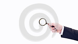 A businessman\'s hand holds a magnifying glass. On a white background. detective.