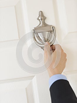 Businessman'S Hand Knocking Door Handle