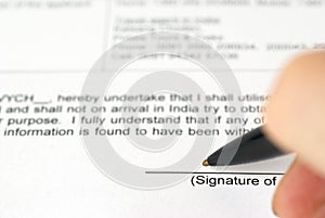 Businessman's hand with pen signing contract