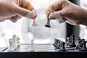 Businessman`s hand playing chess game to development analysis ne