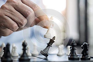 Businessman`s hand playing chess game to development analysis ne