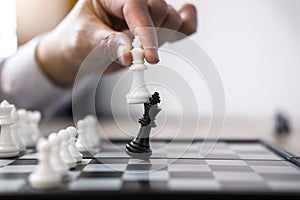 Businessman`s hand playing chess game to development analysis ne