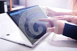 Businessman`s Hand Showing Gantt Chart On Laptop Screen