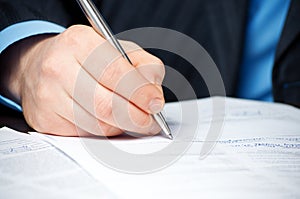 Businessman`s hand signing contract