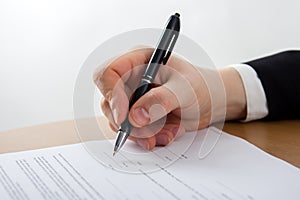 Businessman's hand signing papers. Lawyer, realtor, businessman