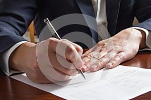 Businessman's hand signing papers. Lawyer, realtor, businessman