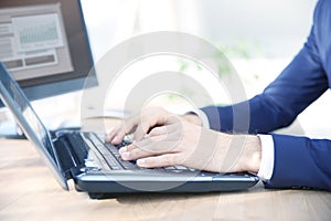 Businessman`s hand typing on keyboard