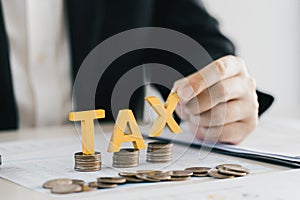 Businessman's hands calculating numbers at a calculator.Tax deduction planning concept