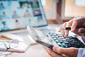 Businessman's hands with calculator and cost at the office and F