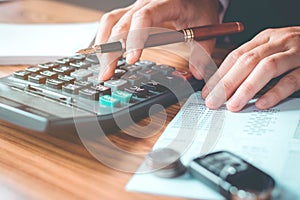 Businessman's hands with calculator and cost at the office and F