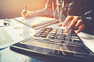 Businessman`s hands with calculator at the office and Financial