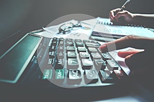 Businessman`s hands with calculator at the office and Financial