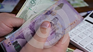 Businessman's hands counts baht banknote
