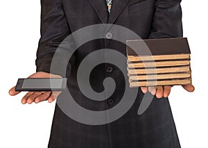 Businessman's hands offering choice between obsolete books or sm