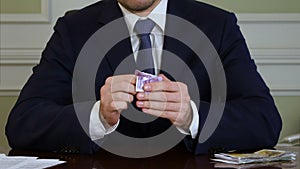 Businessman s hands tear money and throw it