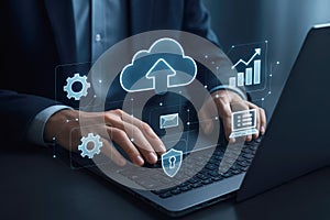 Businessman using laptop with glowing cloud computing and data icons technology