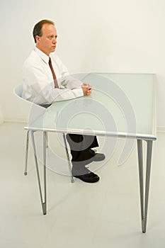 Businessman sat at empty desk