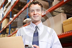 Businessman Scanning Package In Warehouse