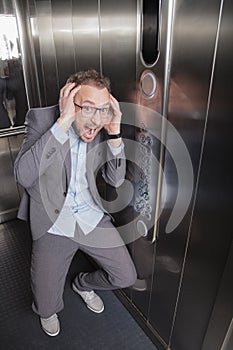 Businessman screaming in the elevator