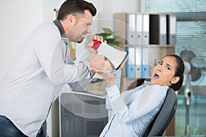 businessman screaming at fatigued woman