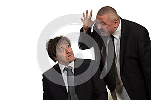 Businessman screaming and fighting at a young colleague