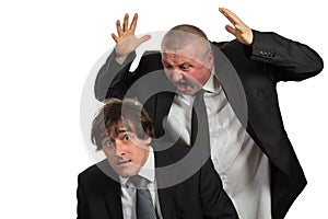 Businessman screaming and fighting at a young colleague