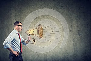 Businessman screaming into a megaphone