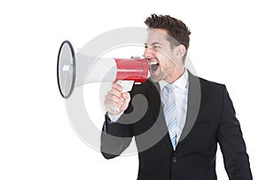 Businessman screaming into megaphone