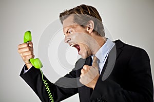 Businessman screaming at phone
