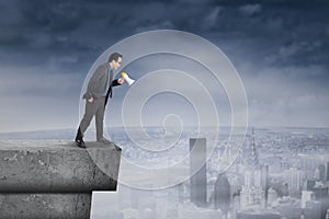 Businessman screaming from the rooftop photo