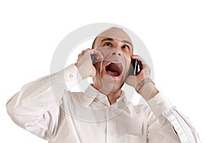 Businessman screaming at telephones