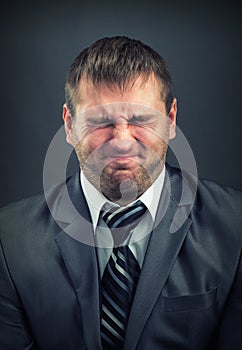 Businessman with screwed-up eyes