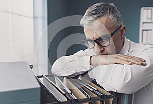 Businessman searching for files in the office