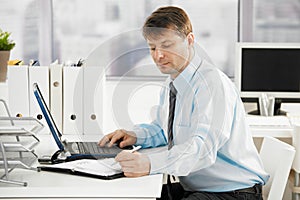 Businessman searching in personal organizer photo