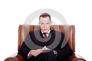 Businessman seated on a chair