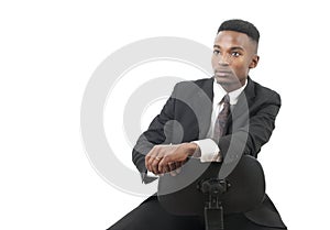 Businessman seated on a chair wearing suit and tie