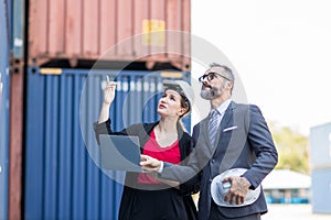 Businessman and Secretary work at Container cargo site check up goods in container. Manager and  customer checking on shipping con