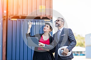 Businessman and Secretary work at Container cargo site check up goods in container. Manager and  customer checking on shipping con