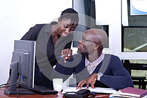 Businessman and secretary working together on a laptop in the of
