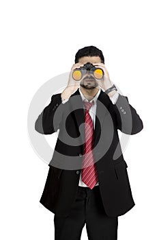 Businessman seeing through binoculars