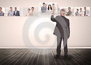 Businessman selecting business people digital interface