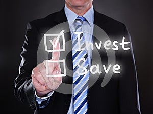 Businessman selecting invest option on the screen