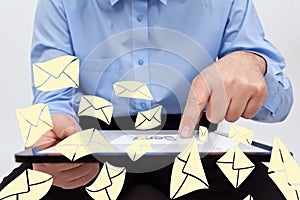 Businessman sending electronic mail using tablet