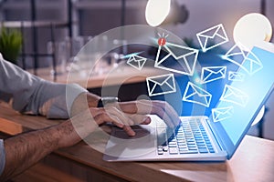 Businessman sending emails at table, closeup