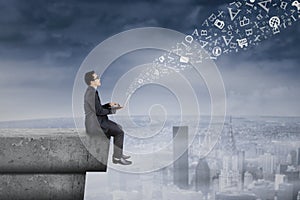 Businessman sending information from rooftop