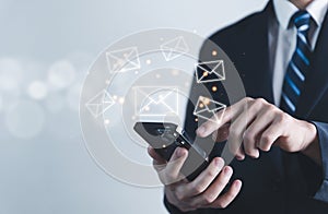 Businessman sending a letter from a smartphone. electronic mail concept is online communication on the Internet network Receiving