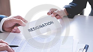 Businessman sending resignation letter to the executive employer boss on desk in order to resign dismiss contract, job placement
