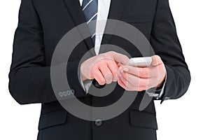 Businessman sending a text message