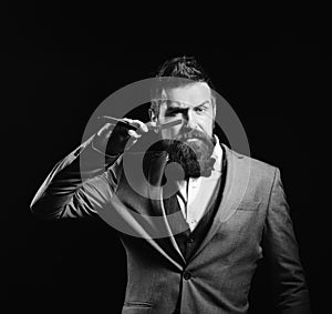 Businessman with serious face isolated on black background. Business and barbershop service concept. Man with long beard