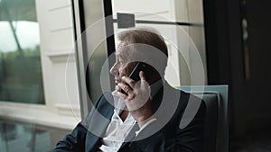 businessman seriously talking on a mobile phone